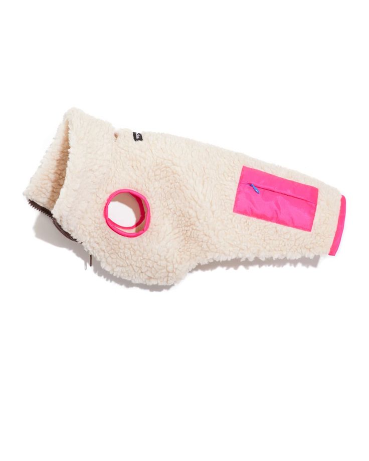 a white and pink dog muzzle with an adhesive tape on it's side