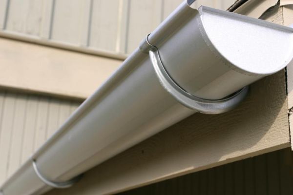 a close up view of the roof of a house with a satellite dish attached to it