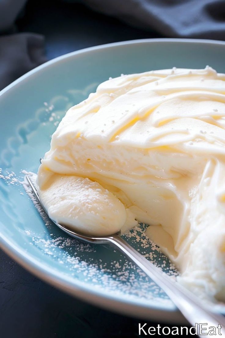 a blue plate topped with ice cream and a spoon