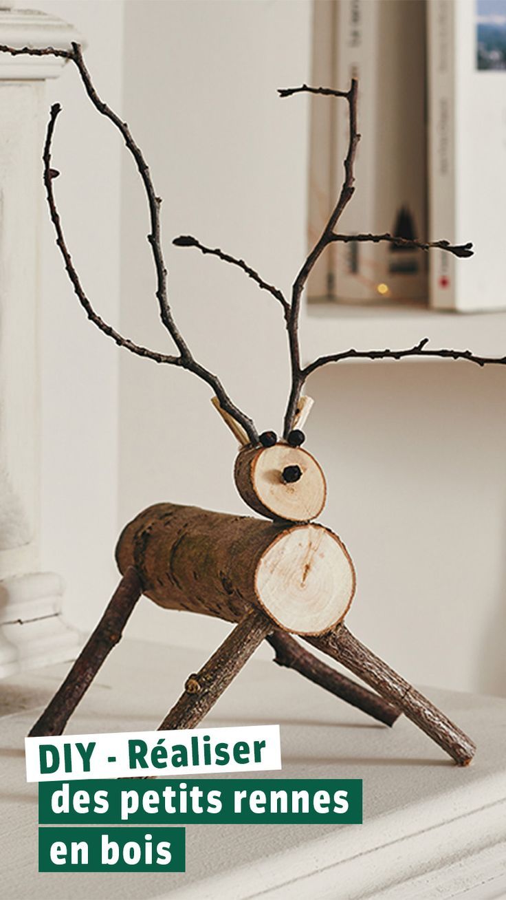 a wooden reindeer is sitting on top of a table