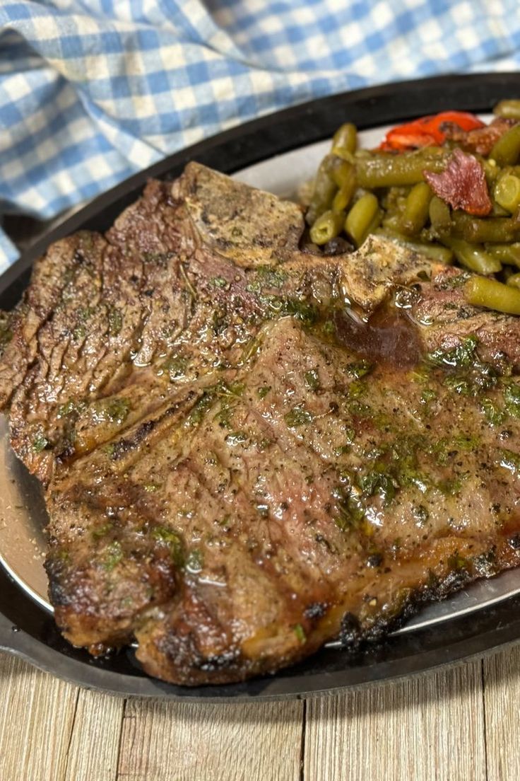 a steak and green beans on a plate