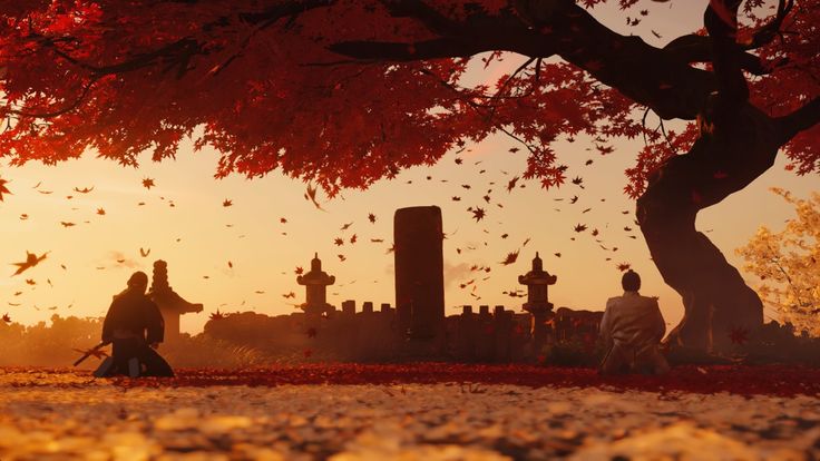 two people walking in front of a cemetery with red leaves on the ground and trees