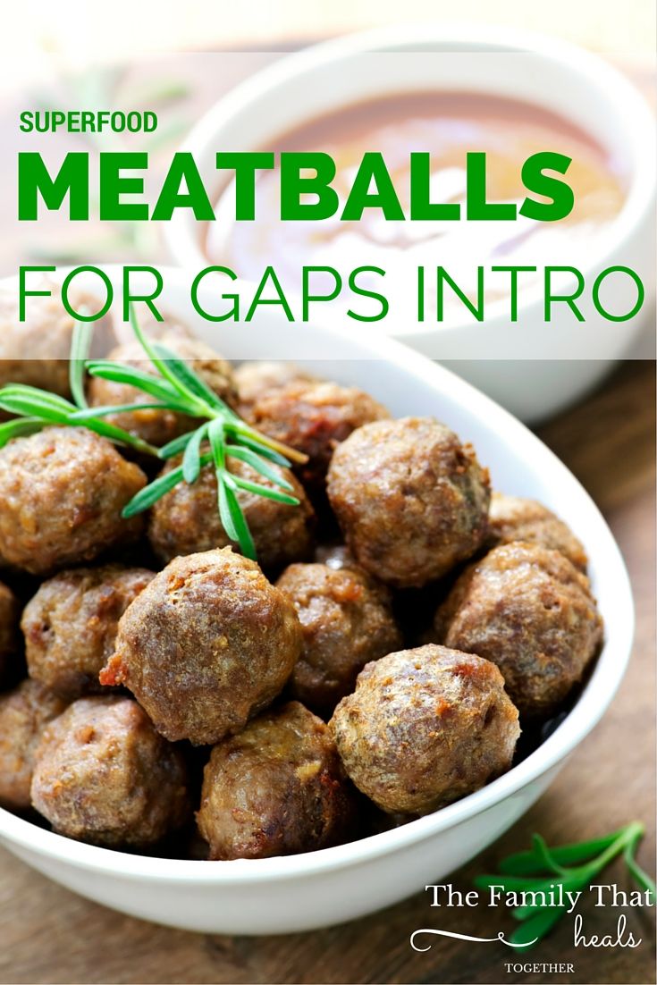 meatballs in a white bowl with rosemary garnish on top and the title superfood meatballs for gaps into