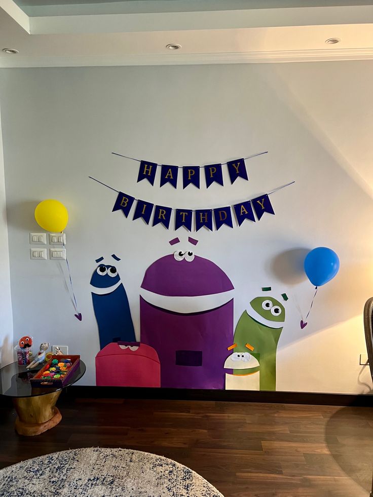 a room with balloons and decorations on the wall