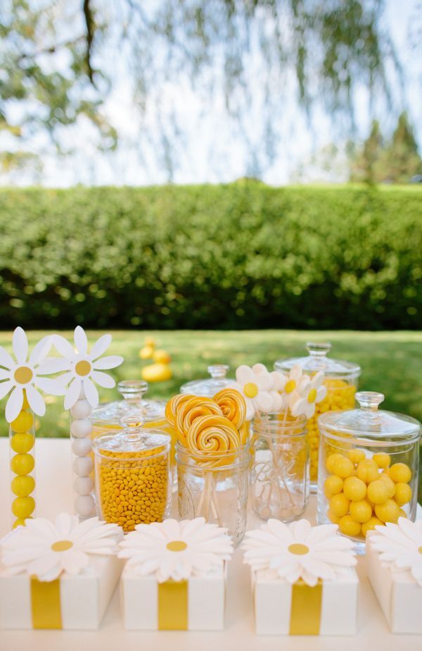 candy bar with yellow and white candies, lollipops, marshmallows