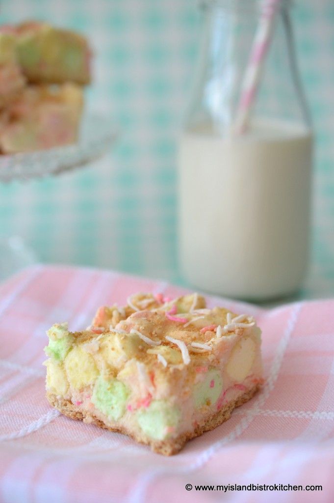 a piece of cake sitting on top of a pink and white checkered table cloth