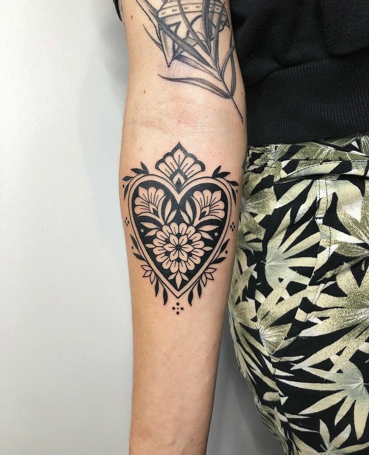 a woman's arm with a tattoo on it and a diamond in the middle