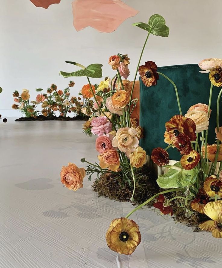 an arrangement of flowers on display in a room