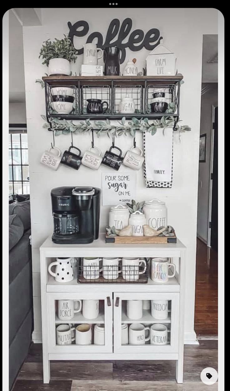 a coffee bar with cups and mugs on the shelves above it, along with other kitchen items