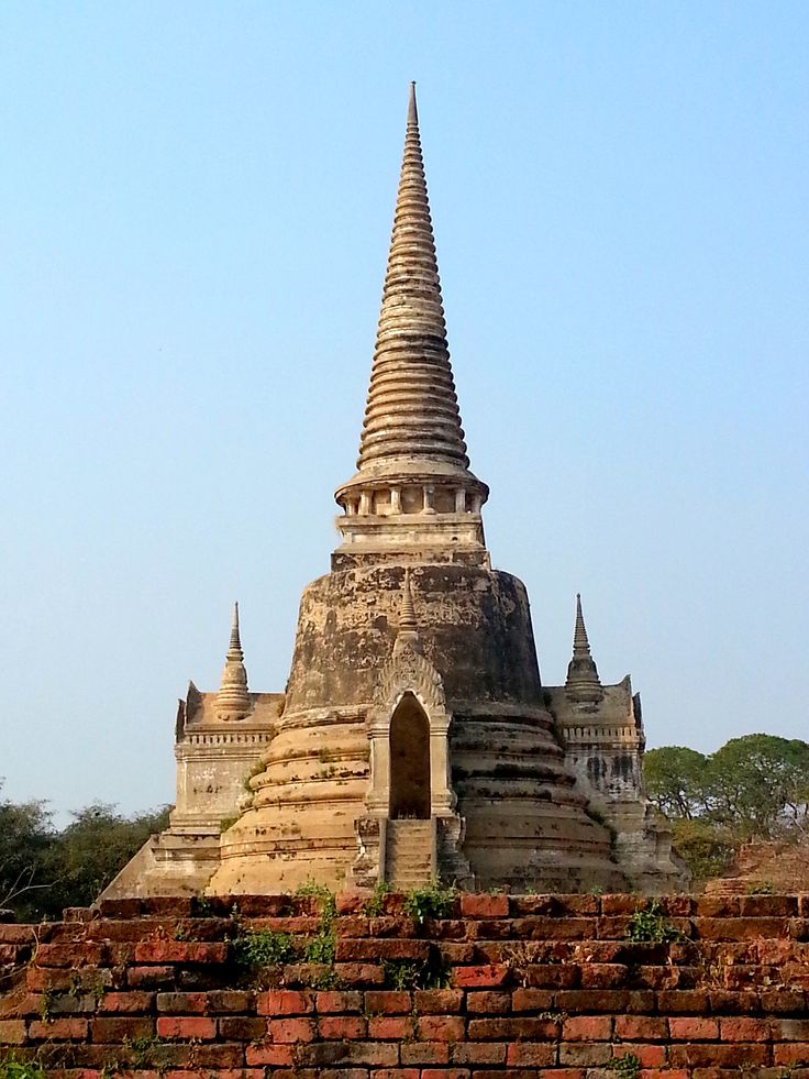 an old building with a very tall spire in the middle of it's roof