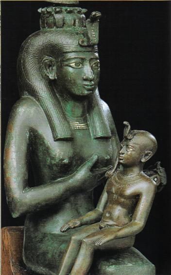 a statue of an egyptian woman holding a child