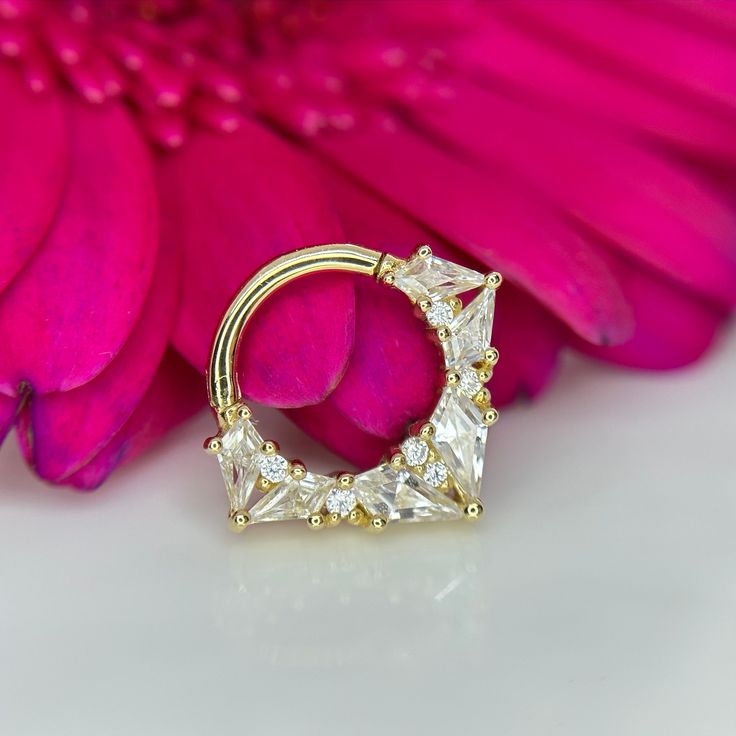 Want 10% off this item? Use code: IRIS10 on our website www.Houseofiris.co.uk Slay your style game with this Legacy CZ Clicker! This stunning piece of jewelry is crafted in solid 14k gold, ensuring a mesmerizing sparkle with every move you make. Closure: Hinged Segment. Material: 14kt Solid Yellow Gold set with Cubic Zirconias. Brand: Buddha Jewelry Organics Ring measures 1.2mm 16g x 8mm internal diameter.  For size and fitting guide check out www.Houseofiris.co.uk Will come beautifully gift box 14k Gold Septum Ring With Prong Setting As Gift, Daith Piercings, Hinged Ring, Buddha Jewelry, Septum Jewelry, Organic Rings, Daith Piercing, Yellow Gold Setting, Cubic Zirconia Rings