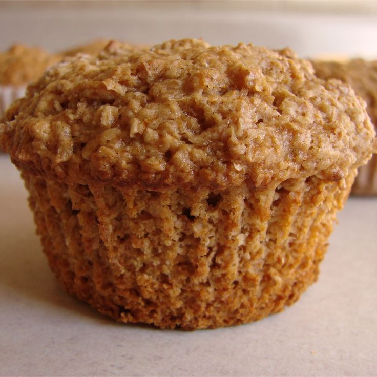 a muffin is sitting on a table with other muffins in the background