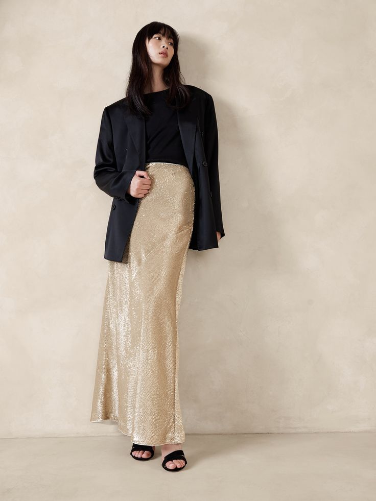 We knew we needed a minimalist silhouette to truly showcase this special sequin fabric, comprised of shining paillettes in either black or a mix of silver and gold.  Here, a fluted maxi skirt cut on the bias let the fabric take center stage.  A-line fit.  Invisible zip at wearer's left.  Fully lined.  A-line fit.  Maxi length.  Model: Size S, 5'10" (178cm). Simple Nye Outfit, Sequin Skirt Long, Sequin Maxi Skirt, Gold Sequin Skirt, Maxi Sequin Skirt, Ny Outfits, Gown Suit, Maxi Skirt Outfits, Minimalist Silhouette