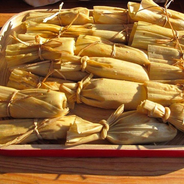 an image of corn on the cob being prepared for consumption in the kitchen or dining room