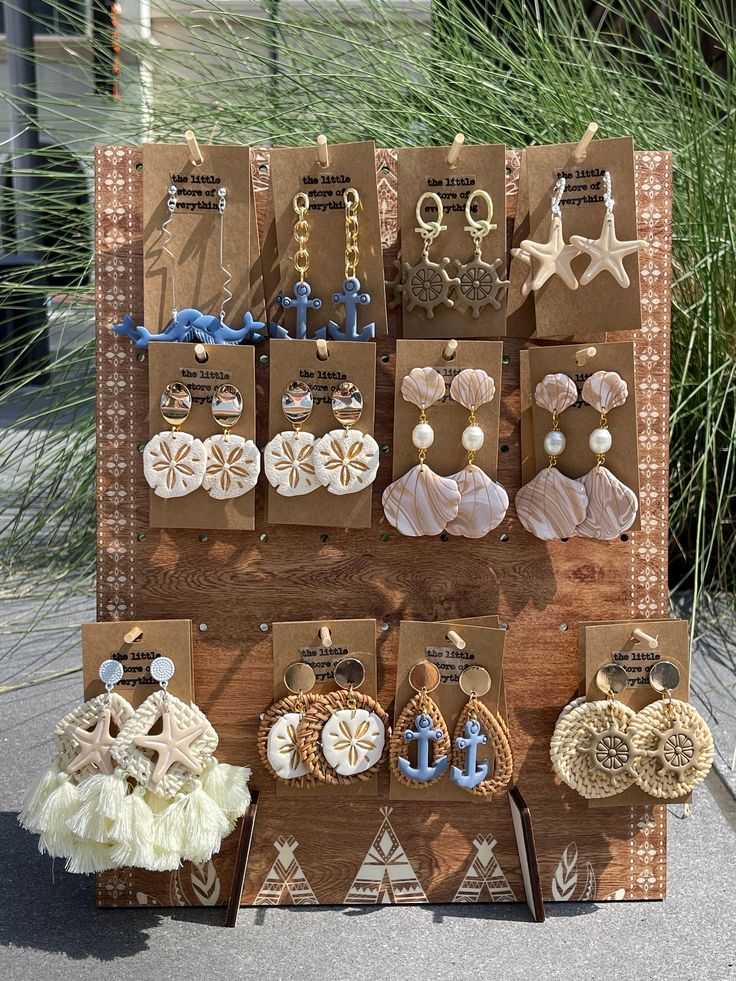 an assortment of earrings are displayed on display