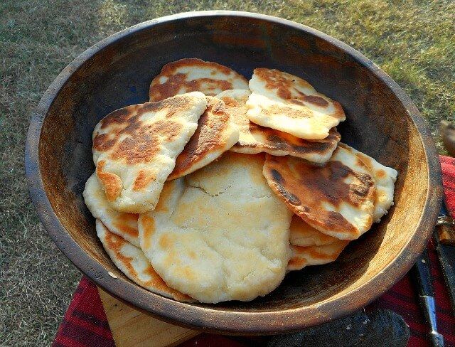 some pancakes are in a bowl on the grass