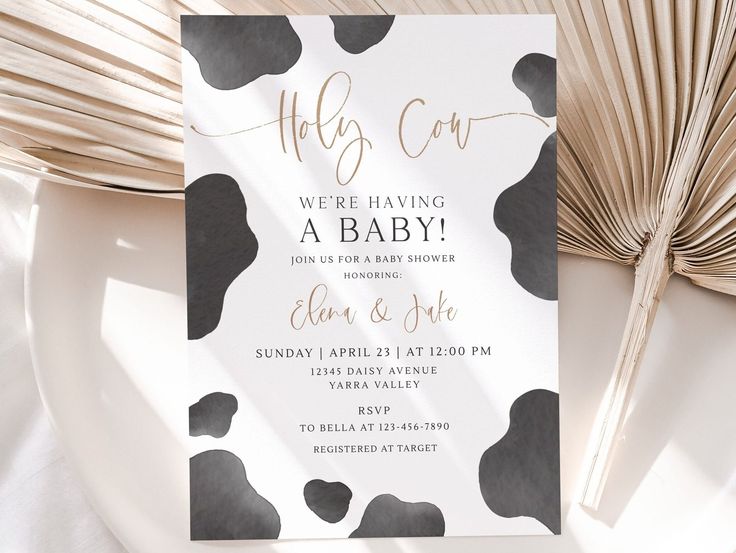 a white and black baby shower with gold foil lettering