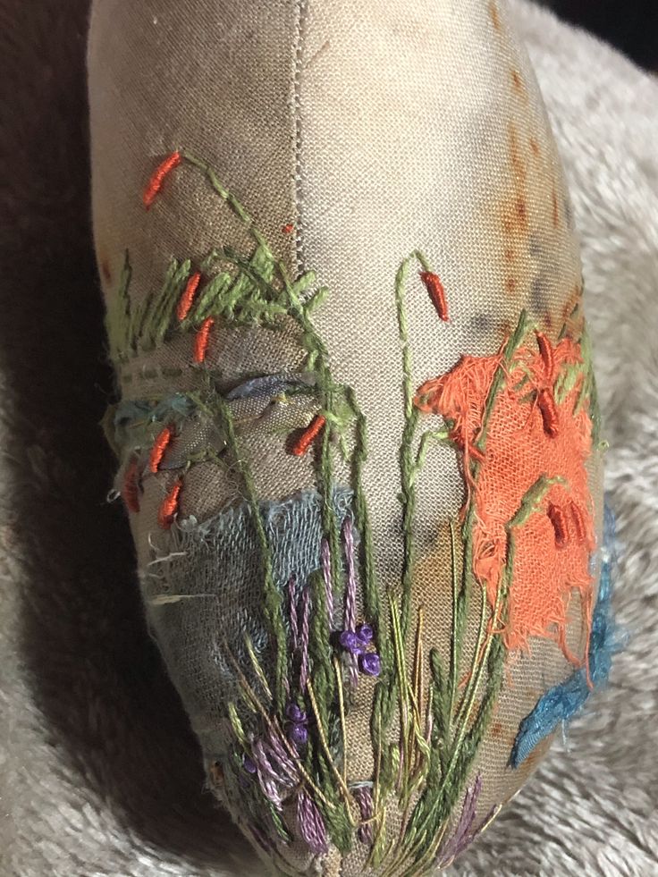 an old hat with flowers and grass on it