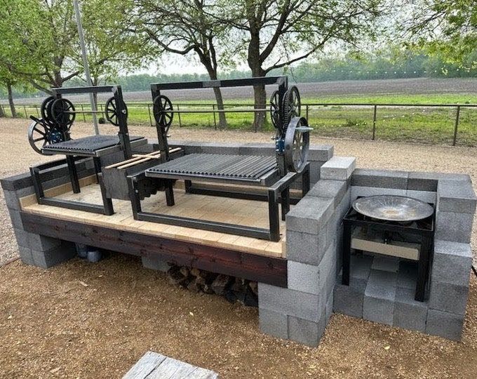 an outdoor table made out of cinder blocks with wheels attached to the back and sides