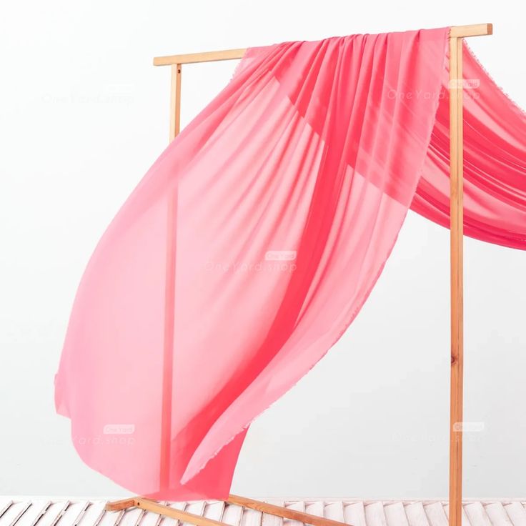 a bed with a pink canopy over it