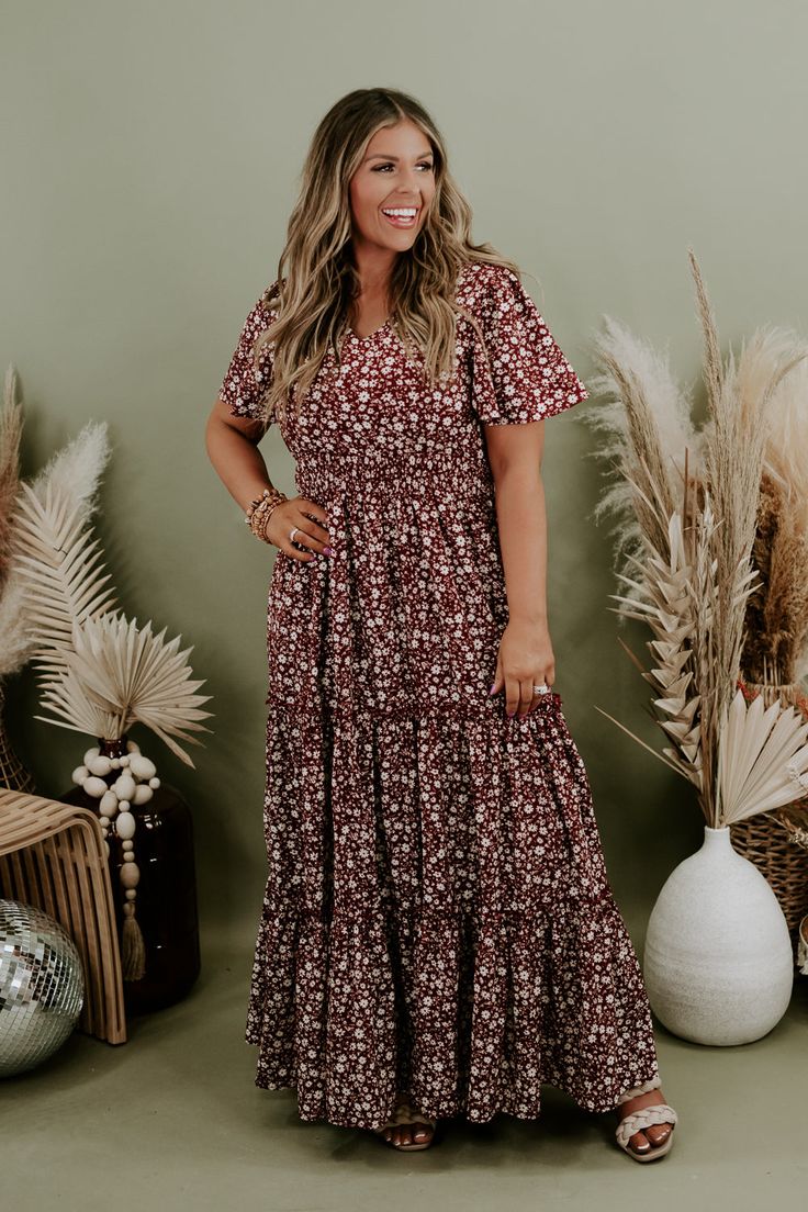 We are adoring the delicate floral pattern on this dress that makes it stand apart from the rest. Our Many Moments Floral Maxi Dress features a v-neckline, elastic waistband, cap flutter sleeves, and a three tiered design skirt. A true essential that transitions flawlessly throughout the seasons! Neckline: V-neckline Fabric: 100% Polyester Details: Lined, Elastic waistband, delicate floral print, tiered skirt Imported Fit: True to size; relaxed fit- Arms: Relaxed flutter sleeve- Chest: Relaxed- Fall Floral Print Short Sleeve Dresses, Floral Print Non-stretch Maxi Dress For Garden Party, Brown Short Sleeve Dress With Floral Print, Brown Printed Flowy Dress, Casual Maternity Dress With Floral Print, Short Sleeve Maxi Dress For Fall Garden Party, Fall Garden Party Maxi Dress With Short Sleeves, Fall Short Sleeve Maxi Dress For Garden Party, Brown Floral Print Maxi Dress For Spring