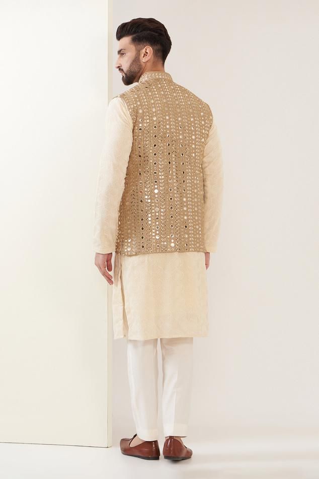 Copper gold Nehru jacket with mirror embroidery and front pockets.
Components: 1
Pattern: Embroidered
Type Of Work: Mirror
Neckline: Band
Sleeve Type: Sleeveless
Fabric: Georgette
Color: Gold
Other Details: 
Note: Pant and kurta worn by the model is not for sale
Occasion: Sangeet - Aza Fashions Bollywood Style Festive Nehru Jacket With Gold Embroidery, Festive Bollywood Nehru Jacket With Gold Embroidery, Gold Bollywood Nehru Jacket For Reception, Bollywood Style Nehru Jacket With Gold Embroidery, Festive Nehru Jacket With Gold Embroidery For Reception, Festive Gold Embroidery Nehru Jacket For Diwali, Gold Nehru Jacket For Designer Wear In Transitional Season, Gold Nehru Jacket For Designer Wear During Transitional Season, Bollywood Style Nehru Jacket With Gold Embroidery For Eid