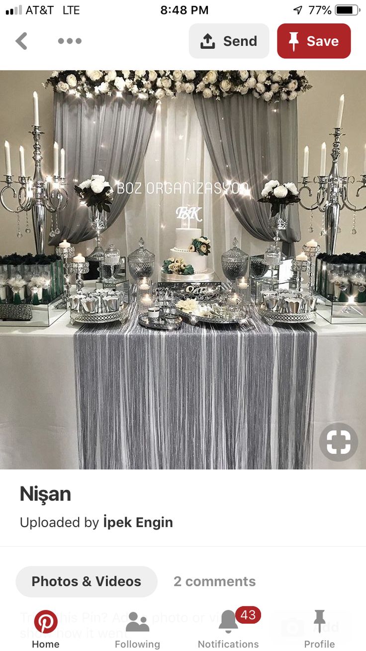 the table is set up with silver and white decorations