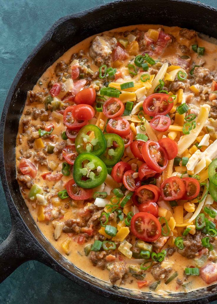 a skillet filled with cheese and vegetables