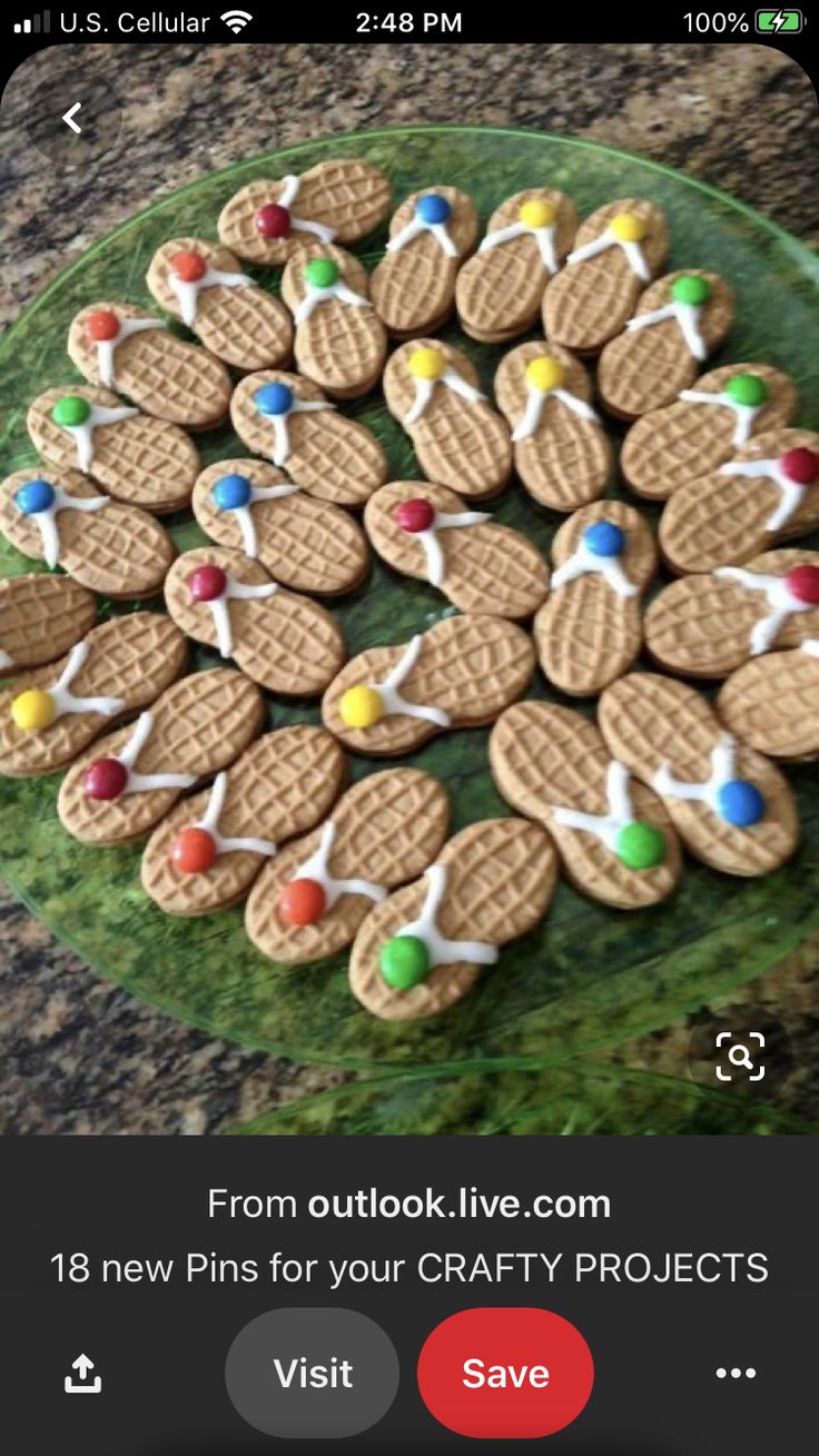 a green plate topped with cookies covered in white icing