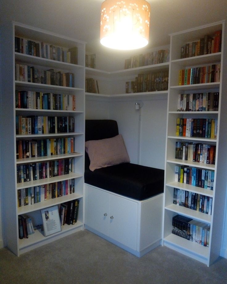 a room with bookshelves and a bed in it