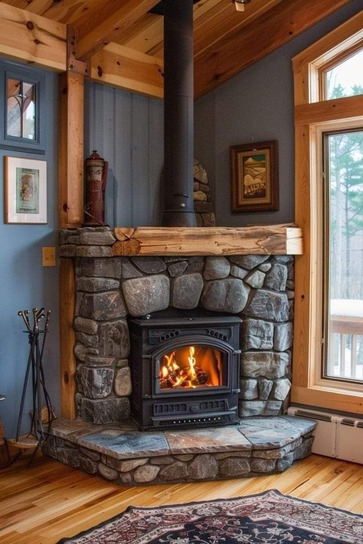 a stone fireplace with wood burning in it