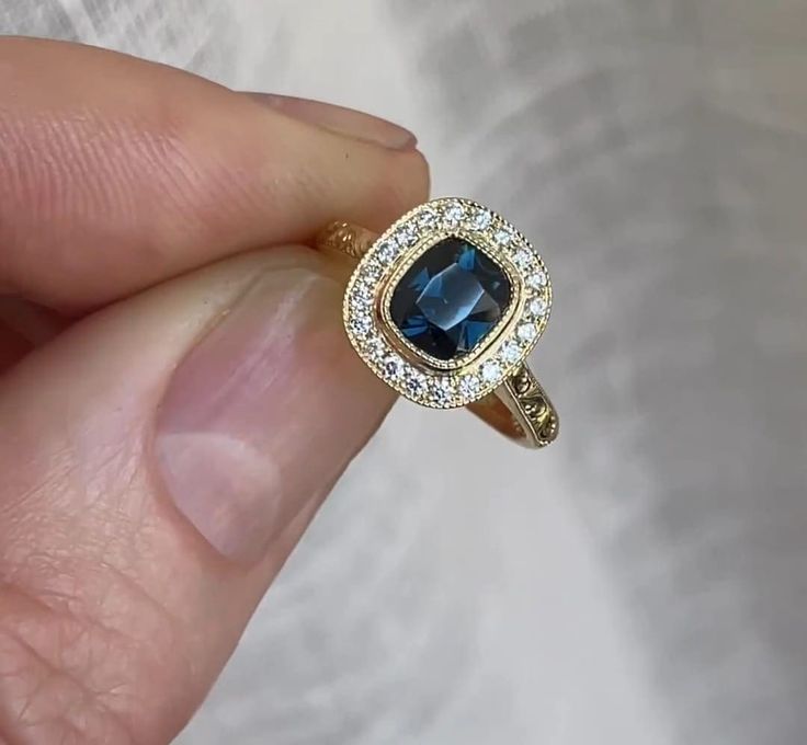 Victorian 2 CT Blue Cushion Cut Sapphire Diamond Ring 10K 14K 18K Solid Yellow Gold Wedding Ring Surrounding Round Cut Diamond Design Ring R I N G M E T A L ✥ Metal : 10K 14K 18K Solid Yellow Rose and White Gold, 925 Sterling Silver ✥ Metal Clarity : 100% Pure ✥ Stamp/Hallmark : Yes. Will be Indicated Inside The Ring M A I N S T O N E S ✥ Type : Sapphire Diamond ✥ Center Diamond Shape : Cushion Brilliant Cut Diamond ✥ Center Diamond Weight : 2 CT ✥ Center Diamond Color : Blue ✥ Side Diamond Shape : Round Cut Diamond ✥ Side Diamond Weight : 0.48 CT ✥ Clarity : VVS1 ✥ Diamond Cut : Excellence R I N G S I Z E S ✥ All Ring Size are Available ✥ Free Sizing ✥ If You Have any Questions With Regards to Sizing Please Contact as ✥ Please Send me a Message If You Need a Size not Listed S H I P P I N Gold Sapphire Diamond Ring With Halo Design, Heirloom Yellow Gold Sapphire Ring With Halo Setting, Yellow Gold Sapphire Ring With Halo Diamond Design, Cushion Cut Sapphire Ring With Diamond Detail For Wedding, Yellow Gold Sapphire Ring With Halo Design, Sapphire Ring In Yellow Gold With Halo Setting, Gold Sapphire Ring With Halo Design, Gold Sapphire Ring With Emerald Cut And Halo Setting, Yellow Gold Sapphire Ring With Princess Cut