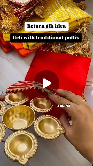 a person is decorating gold dishes with red cloths and other items on the table