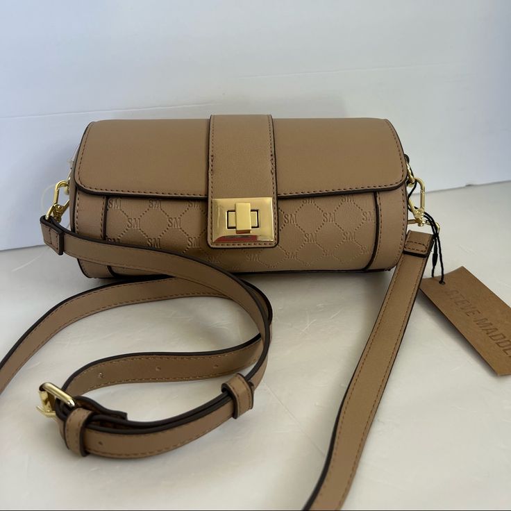 Brand New With Tag Hard To Find Crossbody Shoulder Bag Faux Leather Sand Color Gold Hardware Long Detachable Adjustable Strap Flap With Twist Lock Lined Interior: One Big Compartment One Slip Pocket Approximately 8.5”L X 4”Diameter Gorgeous Elegant Classy Purse Smoke & Pet Free Home Please See My Entire Collection Beige Flap Bag With Adjustable Strap For On-the-go, Brown Box Bag With Gold-tone Hardware For Errands, Beige Box Bag With Adjustable Strap For On-the-go, Beige Crossbody Satchel With Removable Pouch, Beige Crossbody Box Bag For Errands, Beige Box Bag With Detachable Strap For Errands, Beige Crossbody Flap Bag With Gold-tone Hardware, Beige Satchel Box Bag With Adjustable Strap, Versatile Beige Satchel Flap Bag