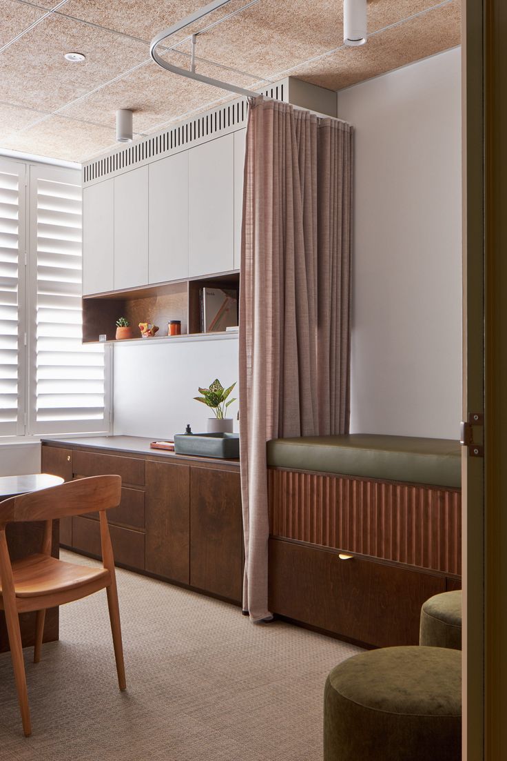 a dining room table and chairs in front of a window