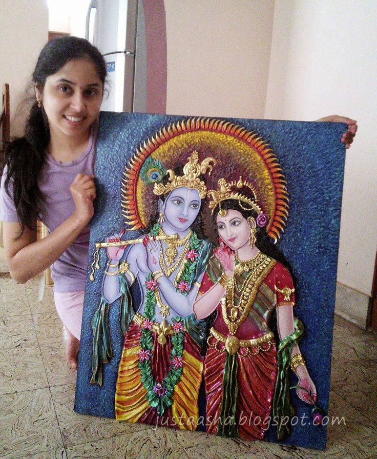 a woman standing next to a painting of two women