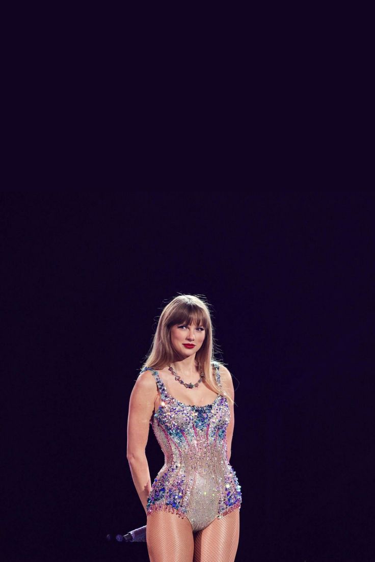 a woman in a bodysuit standing on a stage