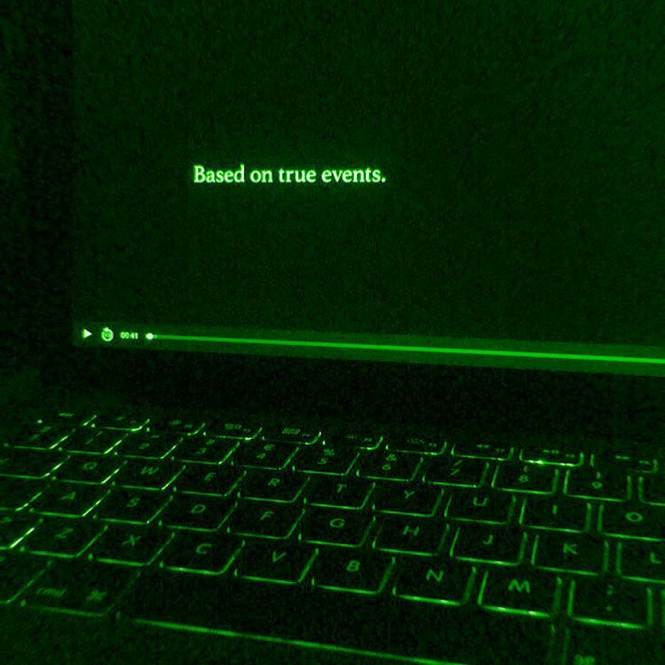 a laptop computer sitting on top of a table in a dark room with the words based on true events