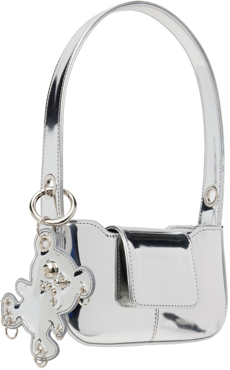 Handcrafted vinyl shoulder bag in metallic silver tone. · Fixed shoulder strap · Detachable graphic charm at shoulder strap · Magnetic press-stud flap · Broadcloth lining · H4.25 x W8 x D2 Supplier color: Silver Silver Satchel Shoulder Bag, Trendy Top Handle Shoulder Bag With Palladium Hardware, Metallic Shoulder Bag With Removable Pouch For Party, Metallic Rectangular Shoulder Bag With Removable Pouch, Trendy Silver Top Handle Shoulder Bag, Trendy Silver Bag With Detachable Strap, Trendy Silver Bags With Detachable Strap, Silver Crossbody Shoulder Bag, Silver Top Handle Shoulder Bag With Removable Pouch