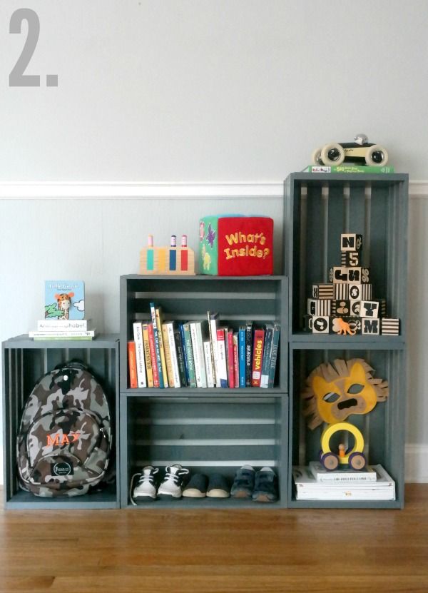 there are two bookshelves on the floor and one is filled with children's toys