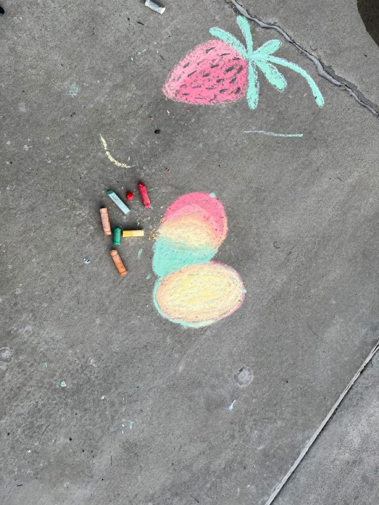 some crayons are laying on the ground next to pineapples and palm trees