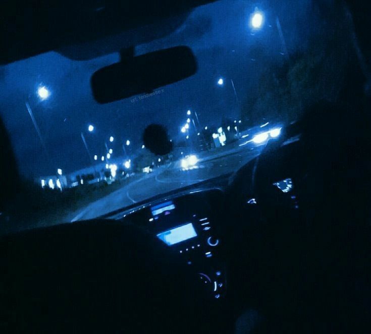 the interior of a car at night with street lights