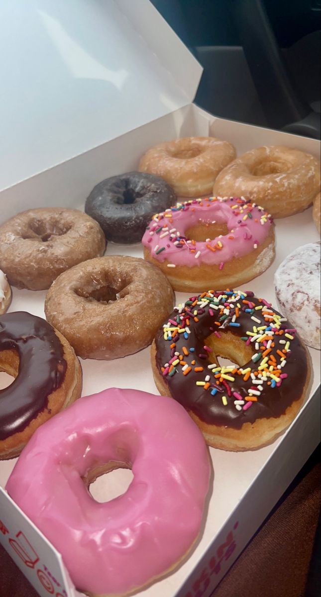 a box filled with lots of different flavored donuts