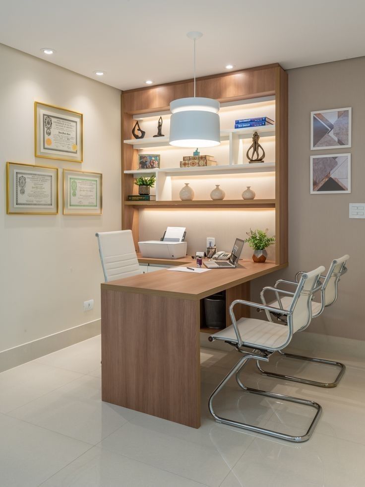 an office with a desk, chair and shelves filled with pictures on the wall behind it