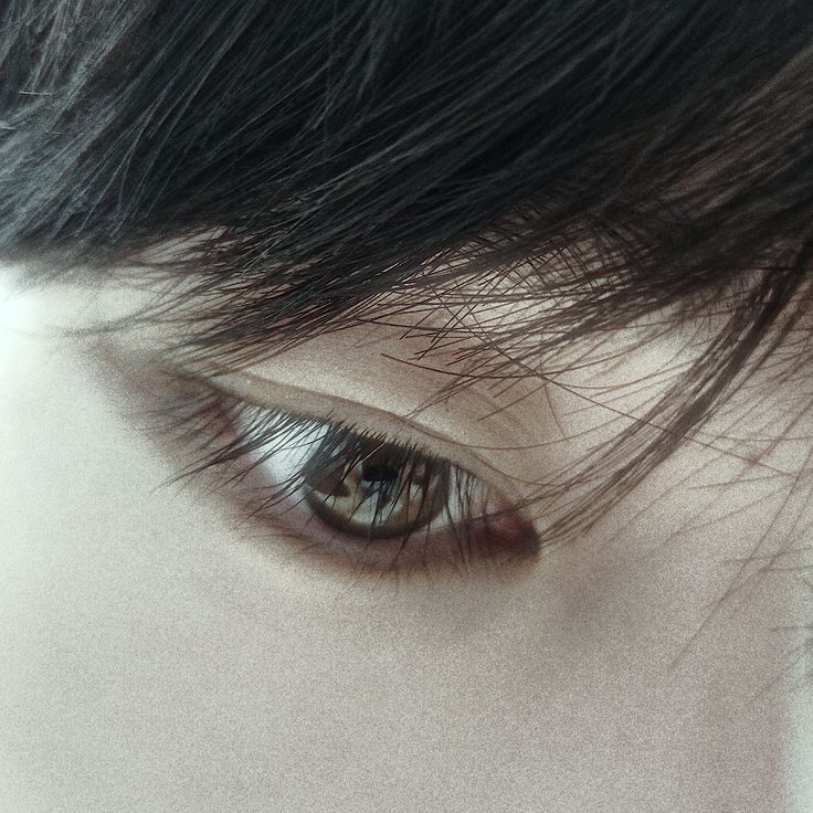 the eye of a woman with long black hair