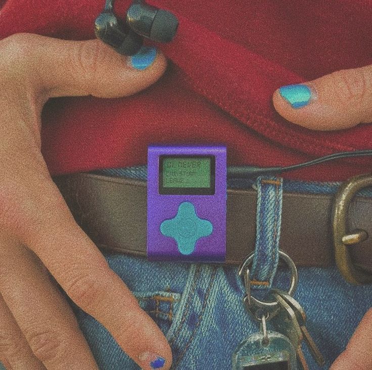 a person with blue nail polish holding a cell phone in their pocket and wearing a red shirt