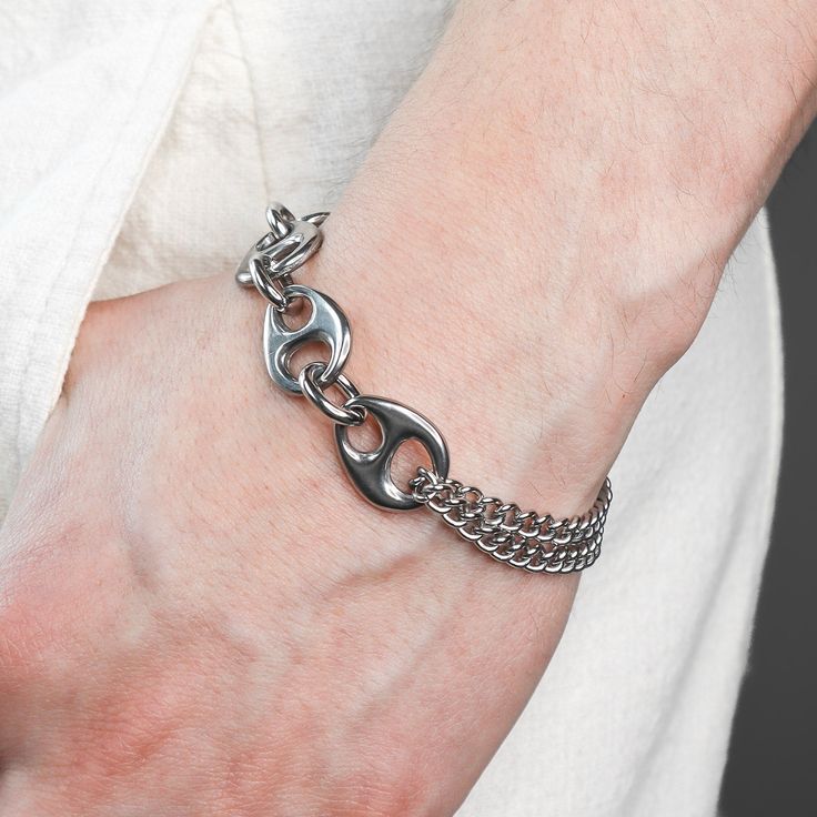 DESCRIPTION: This Pluto bracelet is robust yet comfy. It is made of tarnish resistant stainless steel and finished with a swivel lobster clasp closure. Unique polished liquid like links and a looped rounded curb chain come together with thoughtful construction. Available in four sizes, this bracelet is made just for you. DETAILS: available in 4 sizes 1.5 adjustable tail chain Rhodium plated Hematite stone stainless steel grunge aesthetic modern futuristic unisex FIT: Model has a 7 inch wrist and Metal Cuban Link Bracelet With Oval Links, Cuban Link Bracelet With Curb Chain In Metal, Metal Cuban Link Bracelet With Curb Chain, Metal Cuban Link Bracelet, Trendy Metal Chain Bracelet With Curb Chain, Trendy Metal Curb Chain Bracelet, Adjustable Metal Chain Bracelet With Solid Link, Nickel-free Metal Chain Link Bracelet, Modern Stainless Steel Jewelry With Curb Chain