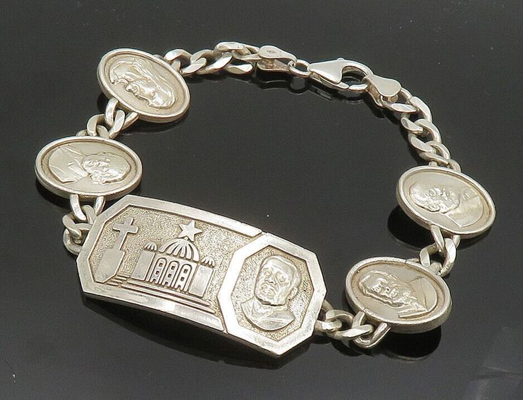 925 Sterling Silver - Shiny Religious Figures Curb Chain Bracelet - BT8018  925 Sterling Silver - Shiny Religious Figures Curb Chain Bracelet - BT8018  Jewelry Type:         Bracelet   Metal Type:            925 Silver  Metal Size:             9.25" Length  .75" Height   Stone Type:            N/A  Condition:              N/A  Jewelry Weight:     39.9 Grams  PLEASE NOTE: THIS ITEM IS PRE-OWNED. ALTHOUGH MOST ITEMS ARE IN VERY GOOD CONDITION, SOME MAY NEED CLEANING AND/OR MINOR REPAIRS. WE MAKE A Nickel-free Sterling Silver Rosary Bracelet, Silver Charms Jewelry For Commemoration, Silver Jewelry With Charms For Commemoration, Silver Commemoration Jewelry With Charms, Commemorative Silver Charm Jewelry, Engraved Oval Sterling Silver Bracelets, Commemorative Silver Jewelry With Charms, Engraved Sterling Silver Oval Bracelet, Engraved Oval Sterling Silver Bracelet