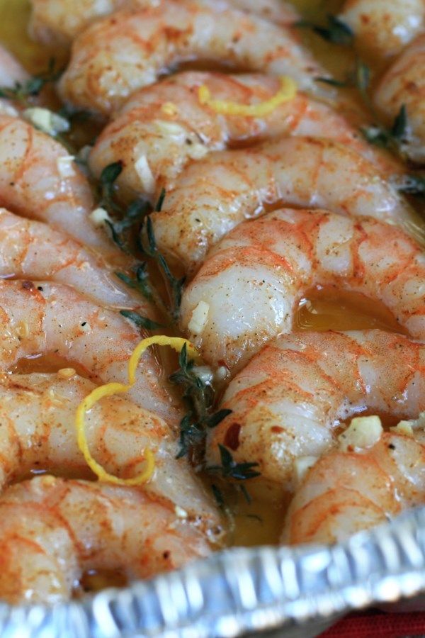 cooked shrimp with lemon and herbs in a pan